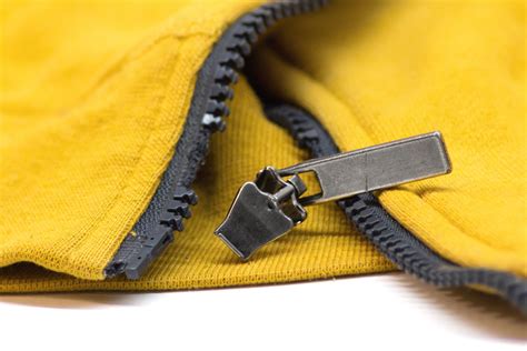 1. Remove the “top stop.”. Use pliers to remove the existing “top stop” from your garment and move the slider up and off the zipper. (If your slider is stuck in “locked” position, use something small like a paper clip to stick under the pull tap loop and pop the lock open to remove the slider.) 2.